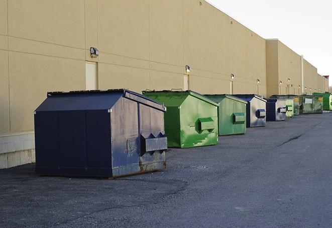 a stack of yellow construction dumpsters on a job site in Macy